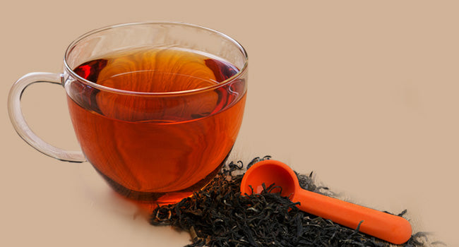 Cup of tea next to loose leaf tea