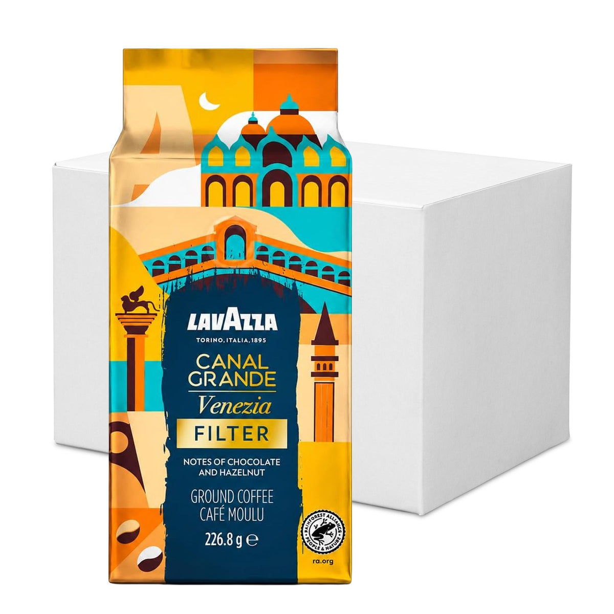 A package of Lavazza Canal Grande Venezia Filter ground coffee stands in front of a plain white box on a white background. The package features a colorful illustration of Venice architecture in orange, yellow, teal, and navy.