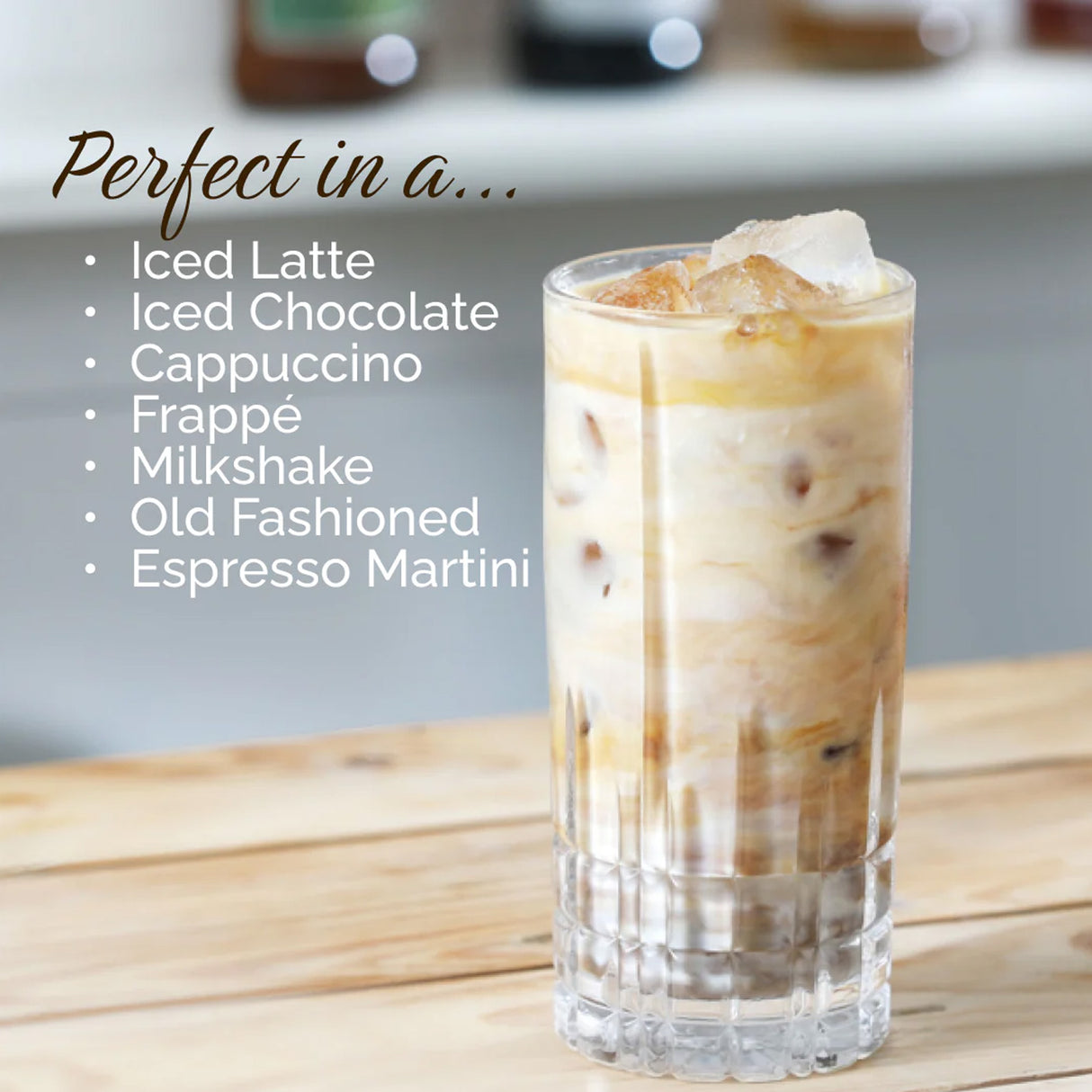 Glass of iced coffee with text listing drink options on a wooden surface