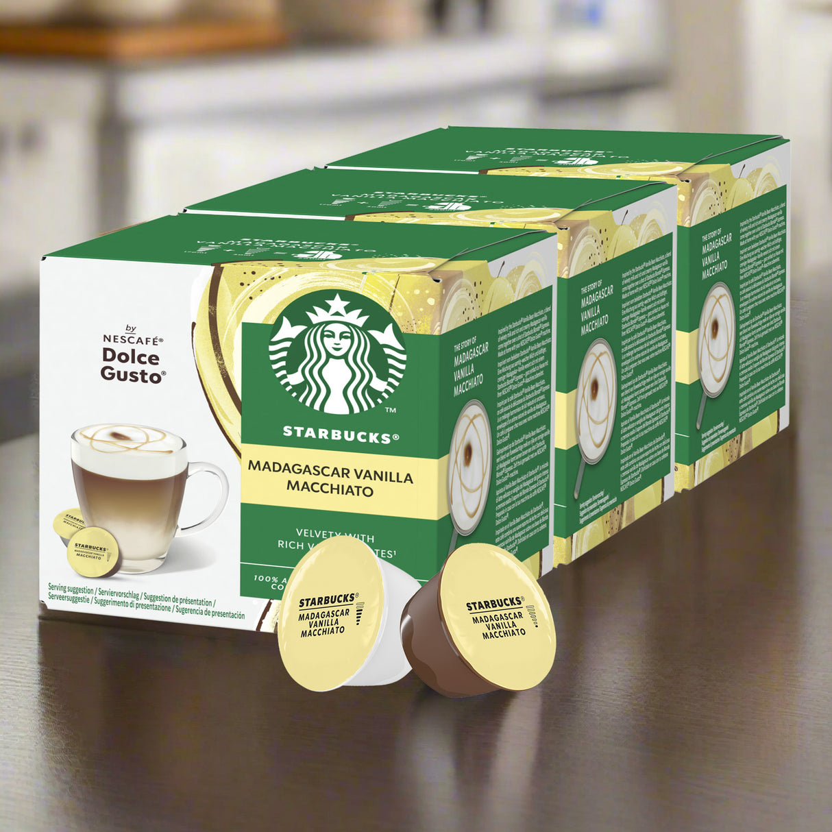 Box of Starbucks Madagascar Vanilla Macchiato Nescafe Dolce Gusto coffee pods on a wooden surface.