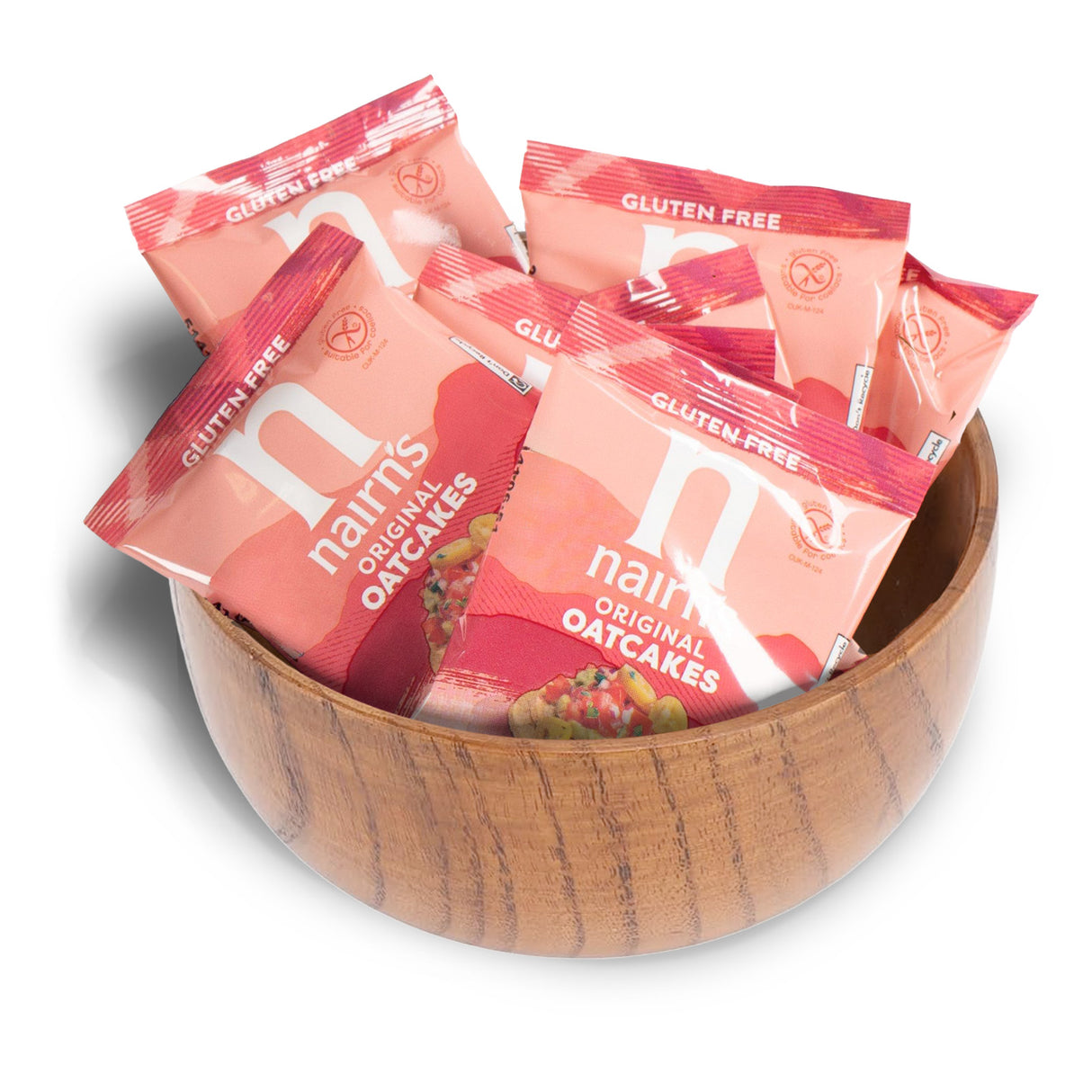 Nairn's Original Oatcakes gluten-free packages in a wooden bowl on a white background