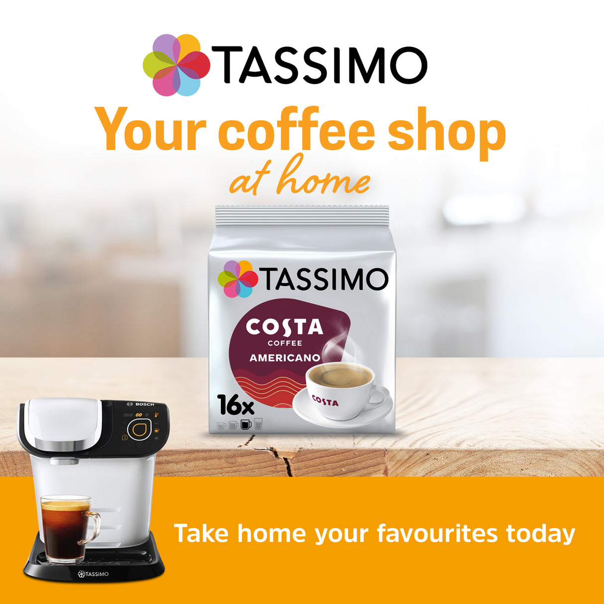 Tassimo coffee machine and Tassimo Costa Coffee packaging on a wooden surface with a blurred background.