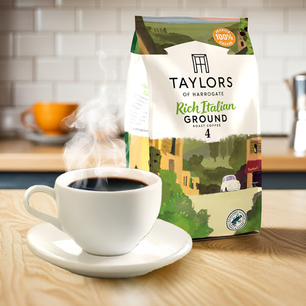 Taylors of Harrogate coffee package with a steaming cup of coffee on a wooden table.