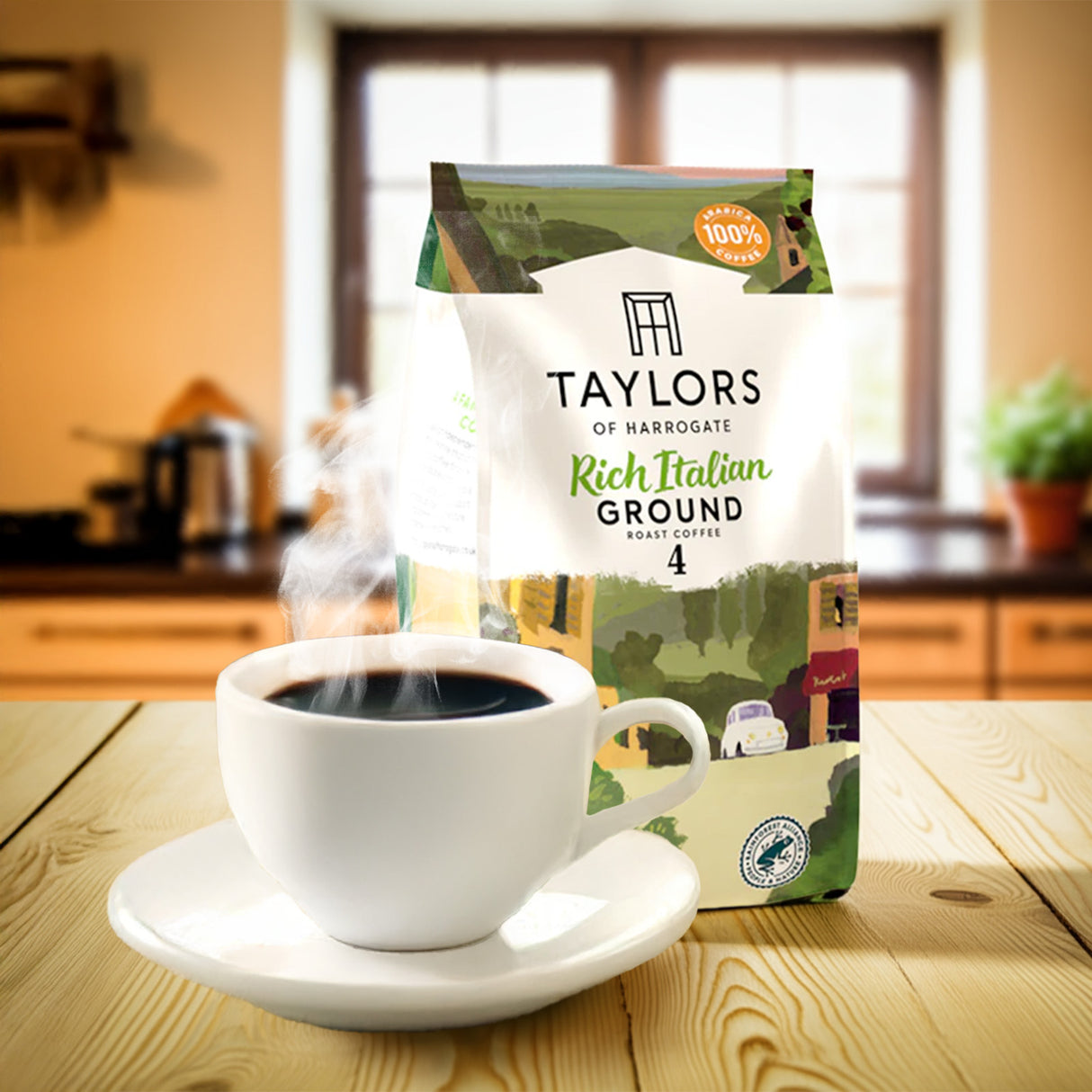 Taylors of Harrogate coffee package with a steaming cup of coffee on a wooden table.