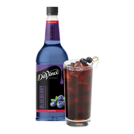 DaVinci Gourmet Blueberry syrup bottle with a glass of iced blueberry drink on a white background
