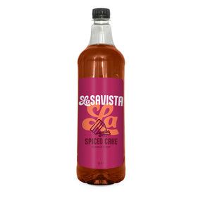 A 1L clear bottle of Savista Spiced Cake Flavour Syrup filled with amber-brown liquid, featuring a bright magenta label with white and orange branding, on a plain white background.
