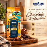 Lavazza Canal Grande Venezia Filter coffee bag displayed on a wooden cutting board with chocolate pieces and hazelnuts, alongside product text and icons on a warm beige background.