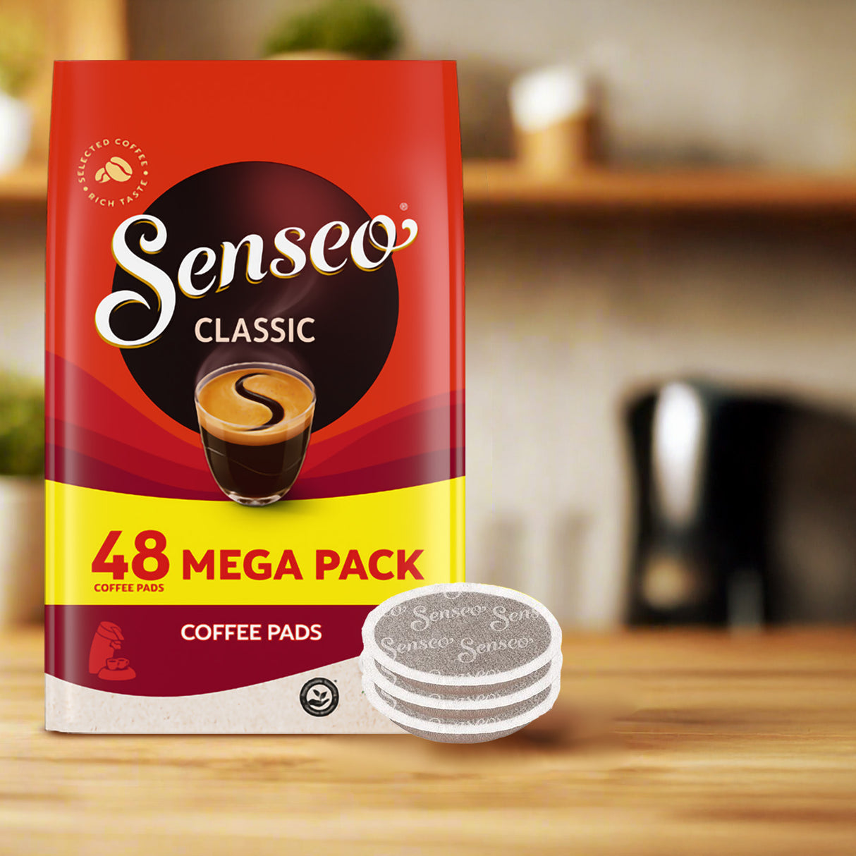 Senseo Classic coffee pads package on a wooden surface with a blurred kitchen background