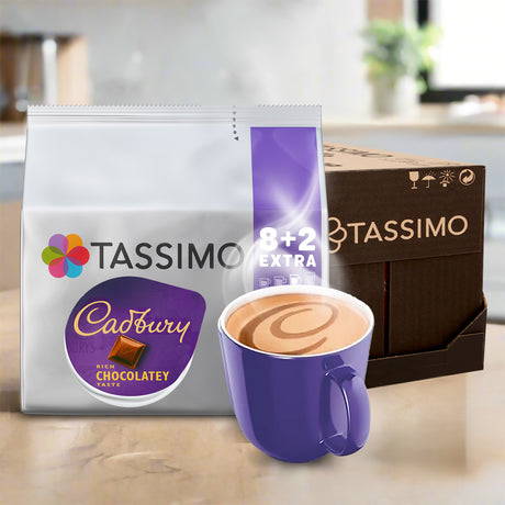 Tassimo Cadbury chocolatey coffee package with a purple mug of coffee on a wooden surface.