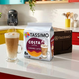 Tassimo Costa Coffee package and a steaming cup of coffee on a kitchen counter.