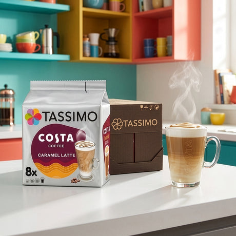 TASSIMO Costa Coffee packages with a steaming glass of caramel latte in a kitchen setting.
