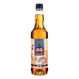 Bottle of Tate & Lyle salted caramel syrup on a white background