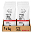 Six bags of Northern Beaches Wood Fired Coffee arranged in a brown cardboard tray, with each bag in a white package featuring black text and a red band labeled 'COFFEE BEANS'.