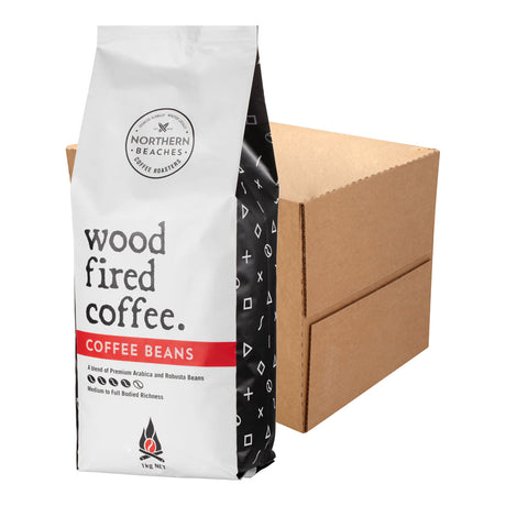 A bag of Northern Beaches Wood Fired Coffee Beans stands in front of a plain brown cardboard box on a white studio background.