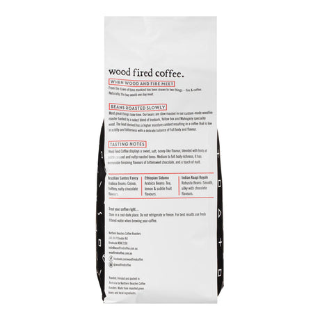 The back of a Wood Fired Coffee bag, showing detailed product information, roast details, tasting notes, and company details in black and red text on a white background.