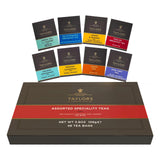 A box of Taylors Assorted Specialty Teas with eight individual tea bag packs arranged behind it on a white background.
