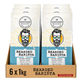 A retail display box containing six bags of Northern Beaches Bearded Barista coffee beans, each bag featuring a white and blue design with a stylized illustration of a bearded man wearing sunglasses.