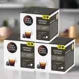 Three boxes of Nescafe Dolce Gusto Espresso Intenso coffee capsules on a blurred kitchen background