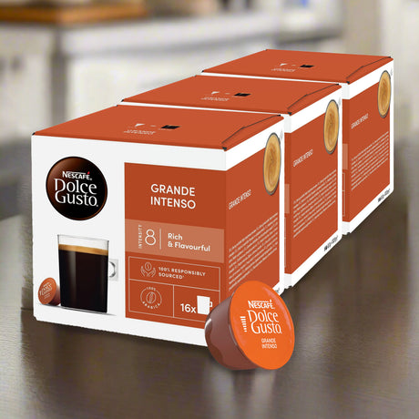 Box of Nestle Dolce Gusto Grande Intenso coffee capsules on a wooden surface.