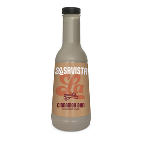 A bottle of LaSavista La Cinnamon Bun Flavoured Sauce on a plain white background. The bottle is a frosted light beige colour with a black cap and a tan label featuring the LaSavista brand logo and cinnamon bun text.