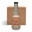 A bottle of LaSavista Cinnamon Bun Flavoured Sauce stands in front of a plain brown cardboard box on a white background.