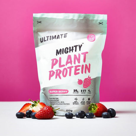 Mighty Plant Protein package with strawberries and blueberries on a pink background