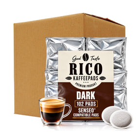 A bulk box of RICO Kaffepads dark coffee filter pods shown with a silver foil bag, a glass of espresso, and two loose filter pods on a white background.