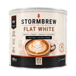 A 1kg canister of Stormbrew Flat White instant coffee drink, featuring a cream-colored label with a brown and black design, and an illustration of a latte with leaf art.