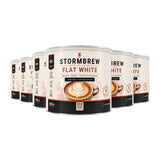 Six cans of Stormbrew Flat White coffee syrup arranged in a staggered row on a white background, with the center can fully visible and the cans fading slightly behind due to perspective.