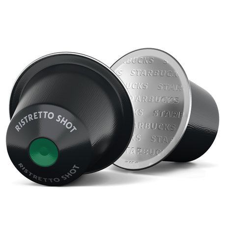 Two coffee capsules, one black and one silver, with 'Starbucks' branding on a white background.