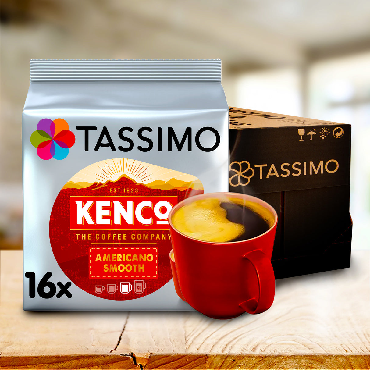 Tassimo Kenco coffee package with a red cup of coffee on a wooden surface