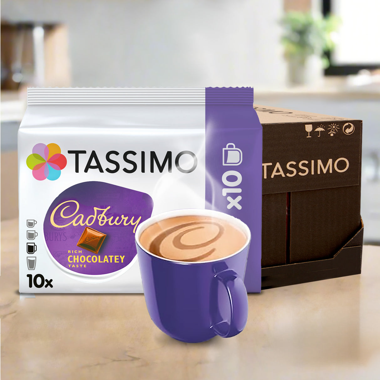 Tassimo Cadbury chocolate coffee pods with a purple mug on a kitchen counter.