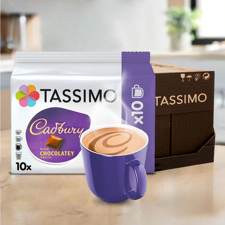 Tassimo Cadbury chocolate coffee pods with a purple mug on a kitchen counter.