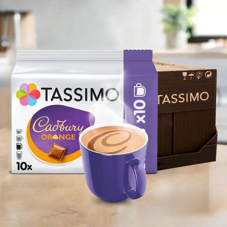 Tassimo Cadbury Orange coffee pods with a purple mug on a wooden surface.