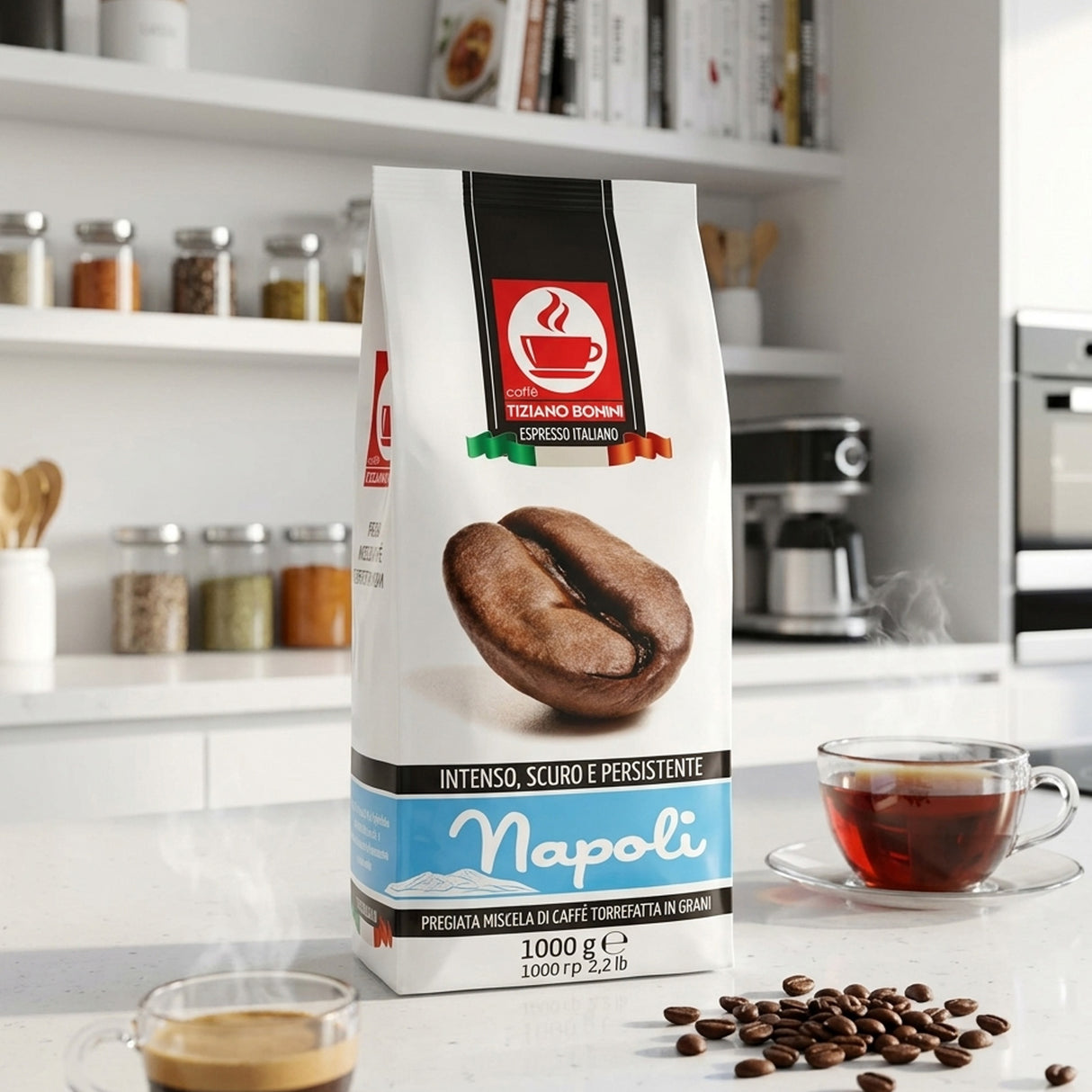 A bag of Napoli espresso coffee stands on a kitchen counter with a cup of espresso, loose coffee beans, and a glass cup of tea in a bright, modern kitchen setting.