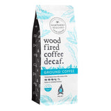 A 500g bag of Northern Beaches Wood Fired Coffee Decaf. Ground Coffee, featuring a white and black bag with light blue botanical illustrations and a bright blue horizontal band.
